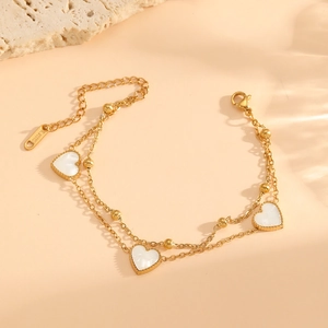 Double-layered golden stainless steel bracelet with three white heart-shaped shell charms