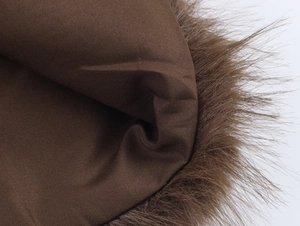 Close-up detail of brown faux fur stitching on a casual knitted jacket for women