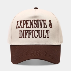Detailed embroidery of Expensive & Difficult text on a two-tone baseball trucker cap