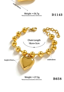 Detail of golden stainless steel beaded bracelet with 25mm heart charm and lobster clasp