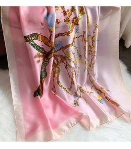 Detailed texture of a silk scarf featuring Van Gogh style almond blossom print on white fur