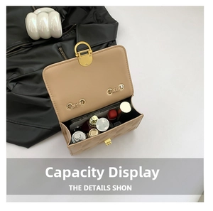 Detail shot of the beige crossbody bag interior showing storage space for cosmetics