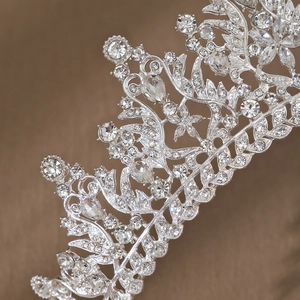 Detailed view of silver bridal crown featuring intricate rhinestone floral and leaf motifs