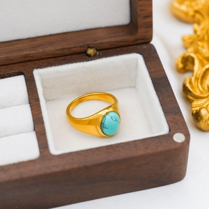 Close-up of a vintage 18k gold plated ring with oval turquoise stone in jewelry box
