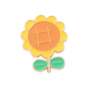 Enamel sunflower brooch with yellow petals and green leaves on white background