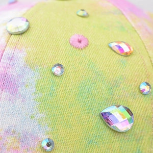 Colorful tie-dye baseball cap with sparkling rhinestones and vibrant textile texture