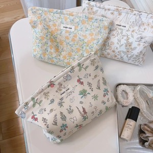Minimalist floral cream fleece makeup pouch with zipper closure and rabbit pattern print