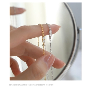 Macro view of dainty s925 silver water wave chains with sparkling zircon stones