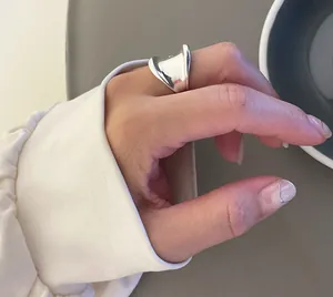 Polished silver irregular wave ring featuring a minimalist sculptural design for women