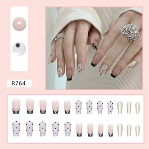 Short ballet French press-on nails with pearl chrome finish and black bow dot accents