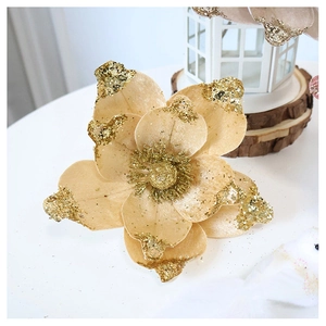 Close-up of champagne velvet poinsettia with gold glitter edges for Christmas tree decoration