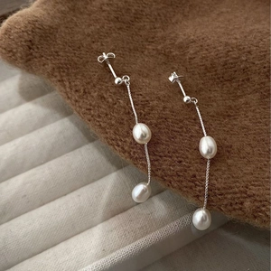 Detail of S925 silver tassel earrings featuring natural freshwater pearls and thin chains