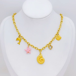 Gold titanium steel ocean necklace with dolphin starfish and conch charms on white bust