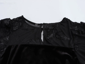 Detail of floral embroidery on black velvet evening dress with mesh stitching