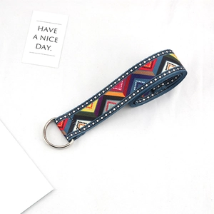 Detail of ethnic canvas belt with geometric pattern weaving and silver D-ring buckle