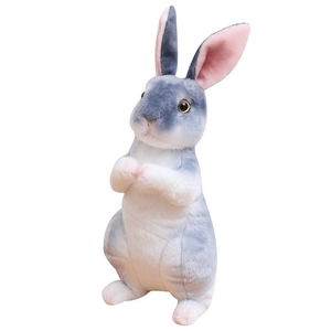 Cute gray and white sitting plush bunny doll with soft pink ears on white background