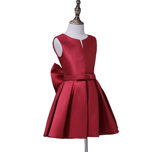 Red sleeveless satin flower girl dress with a waist bow and pleated skirt for parties