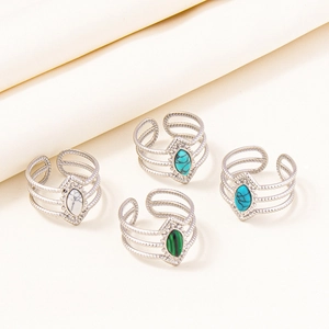Detailed view of four adjustable 304 stainless steel rings with colorful oval gemstones