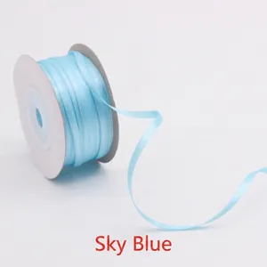 Close-up of 3mm sky blue double-sided satin ribbon roll for gift wrapping and DIY crafts
