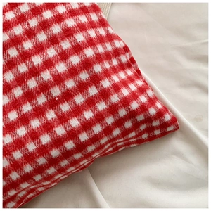 Close-up of red and white checkered fabric showing detailed fiber texture and pattern