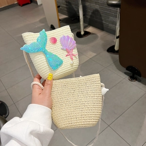 Detail of woven mermaid crossbody bag for girls featuring sequins and shell ornaments
