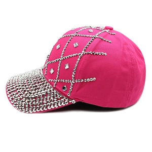 Detailed view of pink cotton baseball cap with rhinestones and diamond pattern