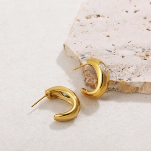 Detailed macro of 18K gold plated hoop earrings featuring a bright oval-shaped zircon stone