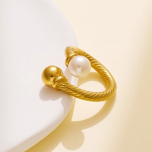 Detailed close-up of 18k gold plated twist ring with pearl and gold bead details