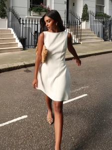Elegant white sleeveless A-line mini dress with a slim fit design for summer street style
