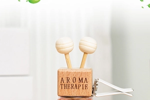 Macro shot of square aromatherapy car clip with wooden top and clear glass bottle