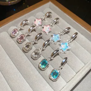Star resin pendants and crystal drop C-shape earrings displayed in jewelry box