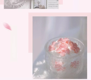 Detailed view of scented peach blossom candle in an embossed vintage glass jar