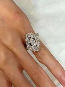 Detailed view of an ornate silver cluster ring with marquise-cut marquise-cut cubic zirconia
