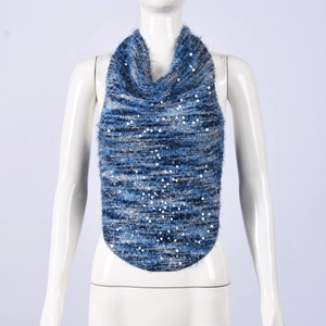Close-up of blue and grey knit texture with shimmering silver sequins on crop top