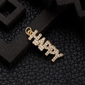 Macro shot of gold-plated Happy letter pendant with sparkling zircons on black leather