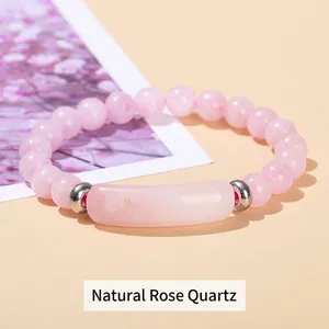 Natural rose quartz beaded bracelet with silver spacers and crystal bar centerpiece