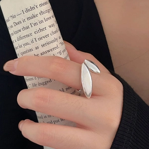 Detail of silver S925 sterling silver leaf design open ring worn on a finger