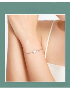 Close-up of a sterling silver beaded bracelet featuring a square-cut zircon stone on wrist