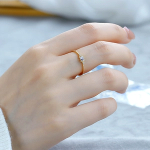 Close-up of elegant gold S925 silver ring with tanzanite gemstone on model's finger