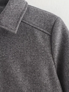 Macro view of grey wool blend fabric texture and meticulous stitching on jacket shoulder