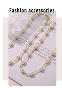 Baroque irregular pearl necklace with gold-plated metal spacers on magazine background