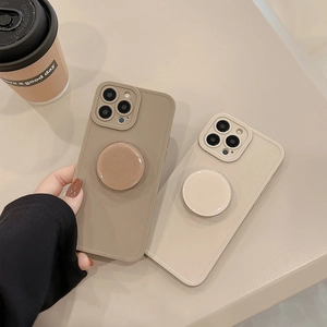 Minimalist iPhone case with circular grip stand in matte brown and beige colors