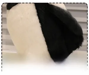 Close-up of plush magpie doll showing thick soft padding and high-quality velvet texture