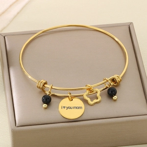 Detail of gold expandable bracelet with i love you mom engraving and floral charms