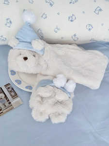 Close-up of white plush bear hooded scarf with light blue sleeping hat and soft fur detail