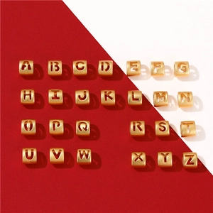 Macro shot of 26 gold plated 14K copper alphabet beads for DIY jewelry making