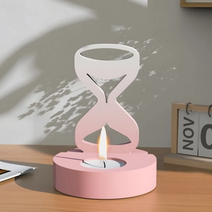 Detail of pink and white hourglass silicone mold used as a candle holder on wood table