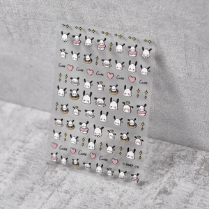 Detail of embossed 3D nail art stickers featuring cute cartoon dog and heart patterns