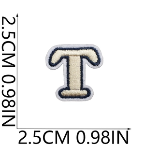 Detailed view of embroidered letter T patch in beige and navy with size measurement