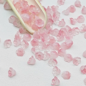 Macro shot of pink gradient lily of the valley glass beads for handmade jewelry DIY